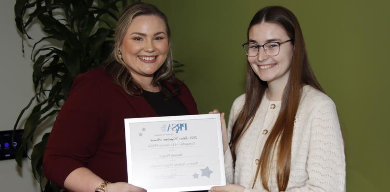 Avery Atkins '25 accepts a Silver Keystone Award from Maggi Barton, former president of PRSA Central PA, president-elect of Mid-Atlantic.